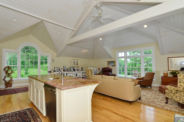175 Pulpit Rock Rd, Woodstock, CT 06281 - kitchen with stainless steel dishwasher, a sink, open floor plan, and light wood finished floors