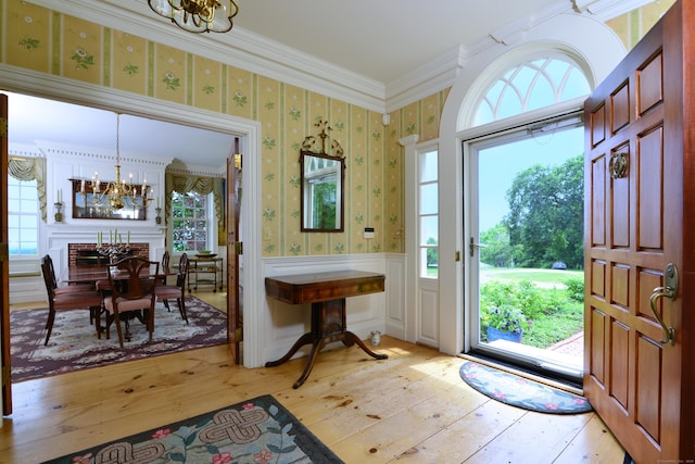 175 Pulpit Rock Rd, Woodstock, CT 06281 - entryway featuring a chandelier, light wood-style flooring, wallpapered walls, plenty of natural light, and crown molding