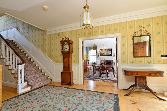 175 Pulpit Rock Rd, Woodstock, CT 06281 - entryway featuring a chandelier, hardwood / wood-style floors, stairway, wainscoting, and wallpapered walls