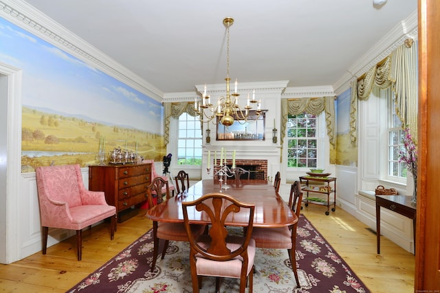 175 Pulpit Rock Rd, Woodstock, CT 06281 - dining space with a chandelier, plenty of natural light, light wood-style flooring, ornamental molding, and a wainscoted wall