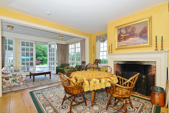 175 Pulpit Rock Rd, Woodstock, CT 06281 - dining room with hardwood / wood-style floors and a brick fireplace