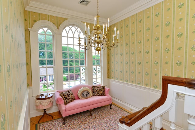 175 Pulpit Rock Rd, Woodstock, CT 06281 - sitting room with wallpapered walls, ornamental molding, a chandelier, and a wainscoted wall