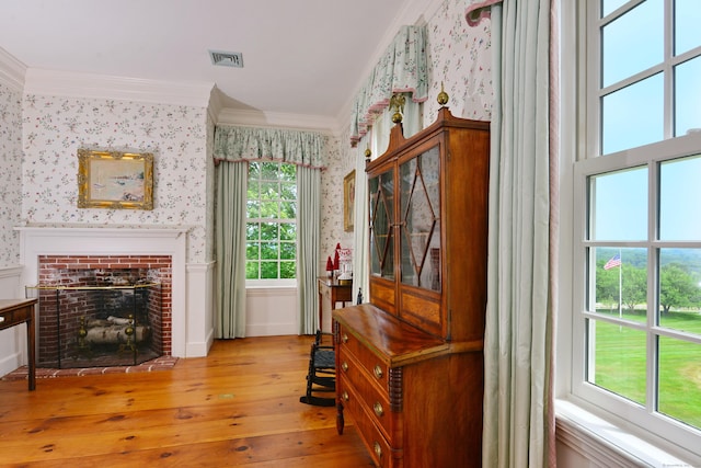175 Pulpit Rock Rd, Woodstock, CT 06281 - living area with wallpapered walls, wood-type flooring, crown molding, and a fireplace
