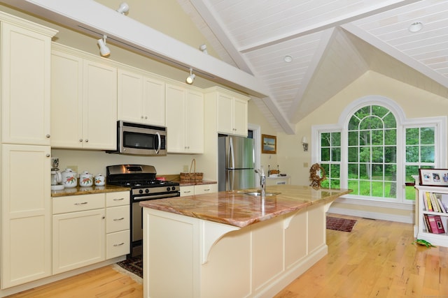 175 Pulpit Rock Rd, Woodstock, CT 06281 - kitchen featuring stainless steel appliances, light wood-style floors, a sink, light stone countertops, and a center island with sink