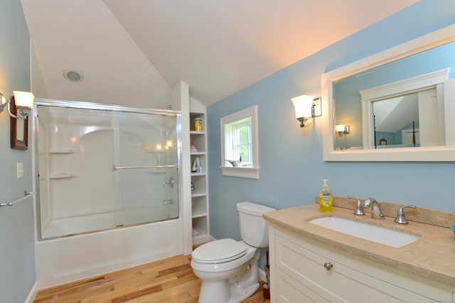 175 Pulpit Rock Rd, Woodstock, CT 06281 - full bath with wood finished floors, toilet, lofted ceiling, vanity, and bath / shower combo with glass door