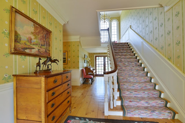 175 Pulpit Rock Rd, Woodstock, CT 06281 - stairs featuring wallpapered walls, wainscoting, hardwood / wood-style flooring, ornamental molding, and a chandelier
