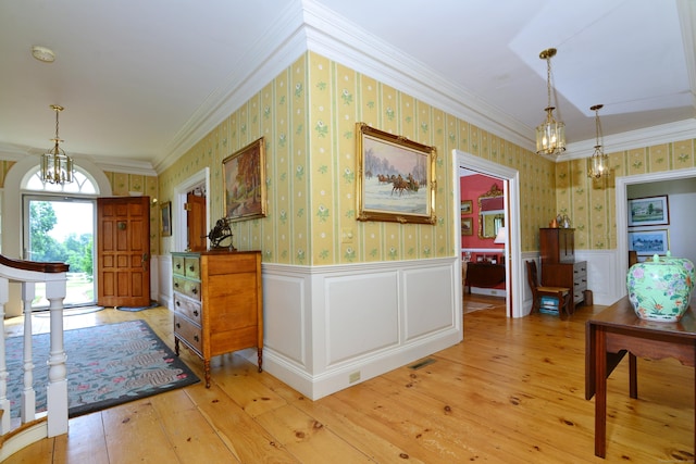 175 Pulpit Rock Rd, Woodstock, CT 06281 - hall with a chandelier, ornamental molding, wainscoting, light wood finished floors, and wallpapered walls