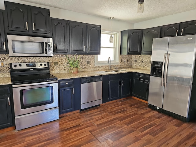 30 Huntley Rd, Killingly, CT 06241 - kitchen with stainless steel appliances, a sink, dark wood-type flooring, backsplash, and a textured ceiling