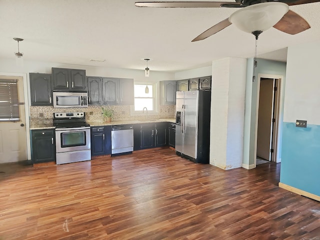 30 Huntley Rd, Killingly, CT 06241 - kitchen featuring stainless steel appliances, dark wood-style floors, tasteful backsplash, and light countertops