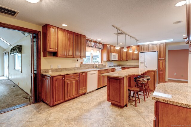 39 Eastgate Ln, Enfield, CT 06082 - kitchen with white appliances, a sink, a breakfast bar, light stone counters, and a textured ceiling