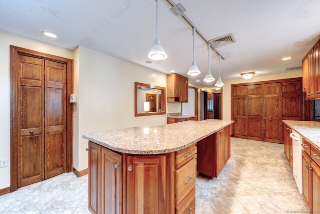 39 Eastgate Ln, Enfield, CT 06082 - kitchen featuring a center island, dishwasher, pendant lighting, brown cabinets, and light stone countertops