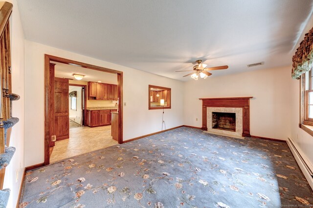 39 Eastgate Ln, Enfield, CT 06082 - unfurnished living room featuring a baseboard heating unit, a ceiling fan, light carpet, a premium fireplace, and baseboards