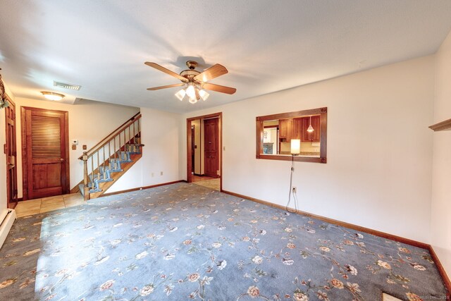 39 Eastgate Ln, Enfield, CT 06082 - unfurnished living room featuring a ceiling fan, carpet floors, stairs, and baseboards