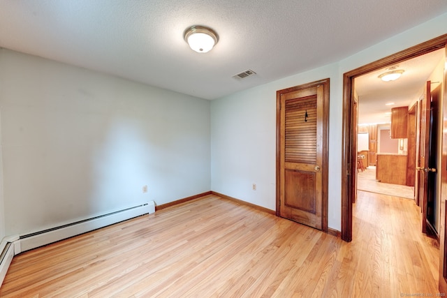 39 Eastgate Ln, Enfield, CT 06082 - unfurnished bedroom with light wood-style floors, a baseboard radiator, a closet, baseboards, and a textured ceiling