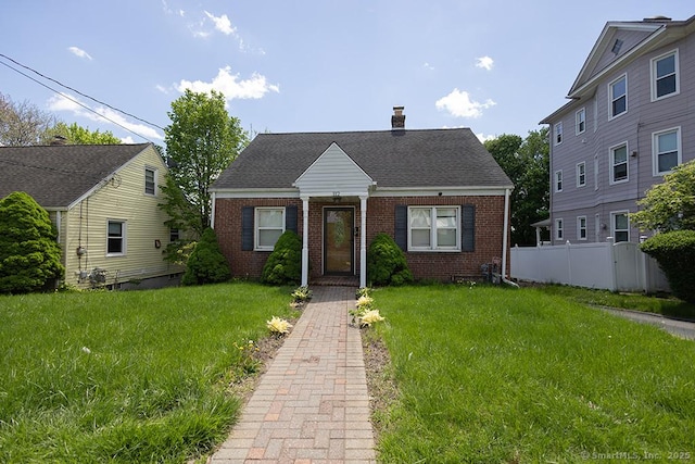 view of front of house with brick siding and a chimney