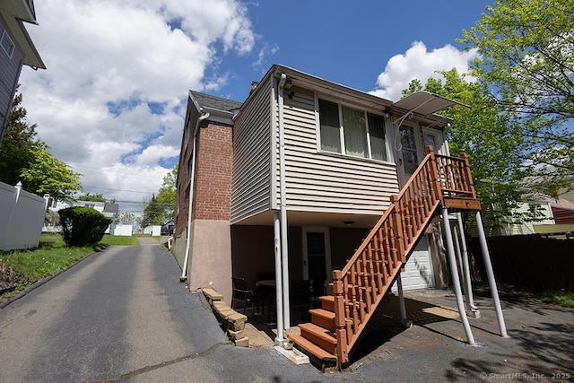 back of house with fence and stairway