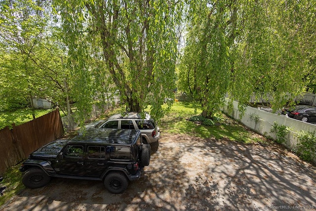 view of parking featuring fence