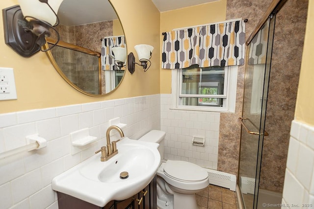 full bath with toilet, vanity, tile walls, a shower with shower door, and tile patterned floors