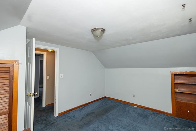bonus room with vaulted ceiling, baseboards, and carpet flooring