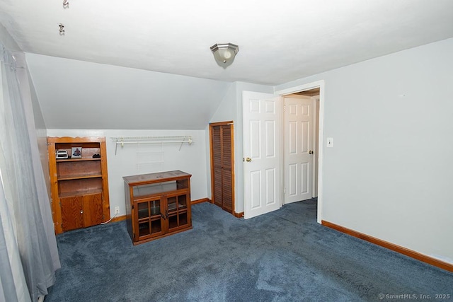 additional living space featuring baseboards, carpet, and vaulted ceiling