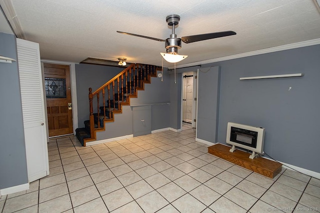 unfurnished living room featuring ceiling fan, stairs, light tile patterned floors, baseboards, and crown molding