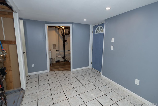 spare room featuring baseboards, recessed lighting, and light tile patterned floors