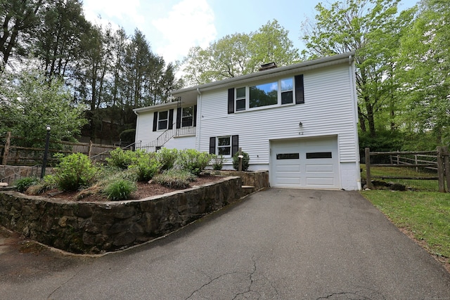 42 Wilridge Rd, Ridgefield, CT 06877 - view of front of house with an attached garage, driveway, and fence