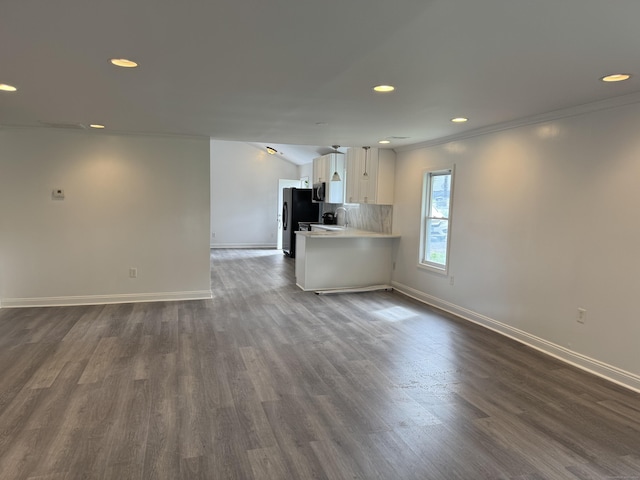 39 Medford St, West Haven, CT 06516 - unfurnished living room featuring recessed lighting, baseboards, dark wood-type flooring, crown molding, and a sink