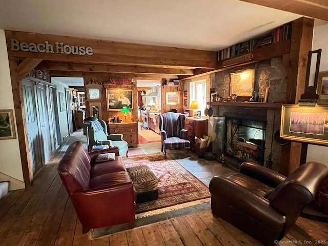 living room featuring hardwood / wood-style floors, a fireplace, and wood walls