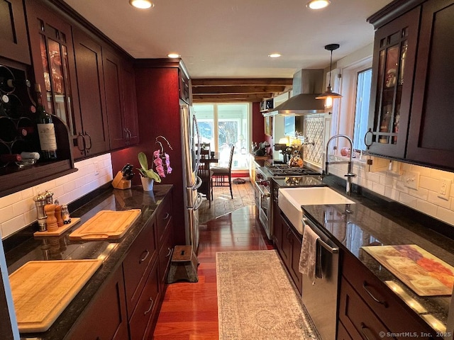 kitchen with range hood, appliances with stainless steel finishes, backsplash, recessed lighting, and a sink