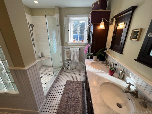 bathroom featuring a shower stall and double vanity
