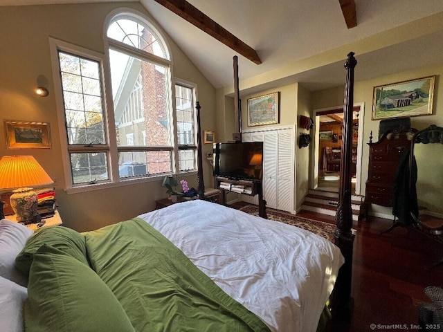 bedroom with lofted ceiling and wood finished floors