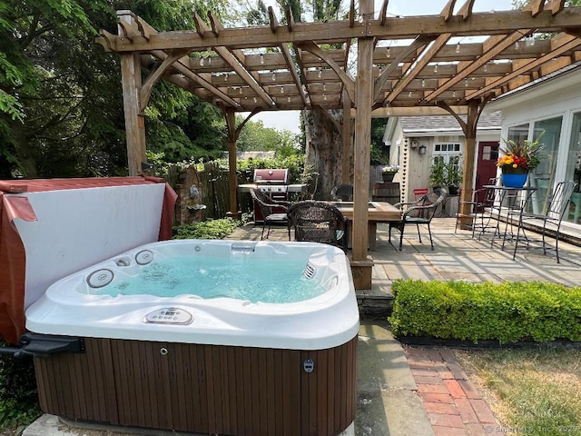 view of patio featuring a hot tub, a pergola, outdoor dining space, and fence