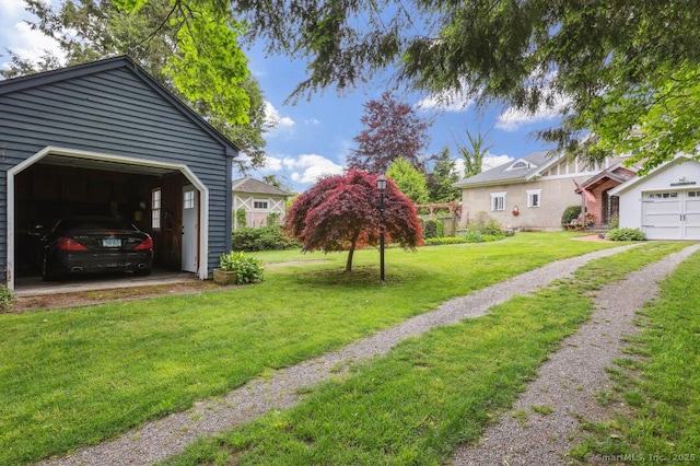 9 Columbus Ave, East Lyme, CT 06357 - view of grassy yard featuring a garage and an outbuilding