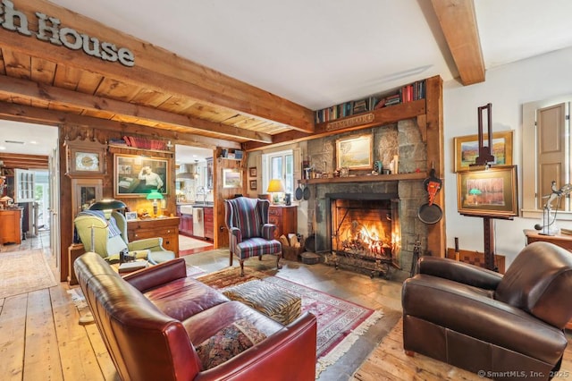 9 Columbus Ave, East Lyme, CT 06357 - living room with beamed ceiling, a stone fireplace, and hardwood / wood-style flooring