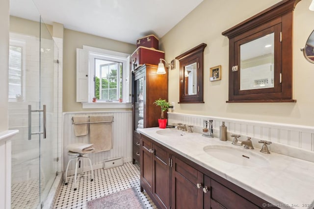 9 Columbus Ave, East Lyme, CT 06357 - full bathroom with double vanity, a shower stall, and a wainscoted wall
