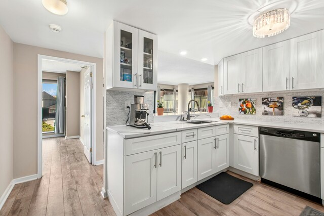 127 Greyrock Pl Unit 502, Stamford, CT 06901 - kitchen with stainless steel dishwasher, a sink, tasteful backsplash, and white cabinets