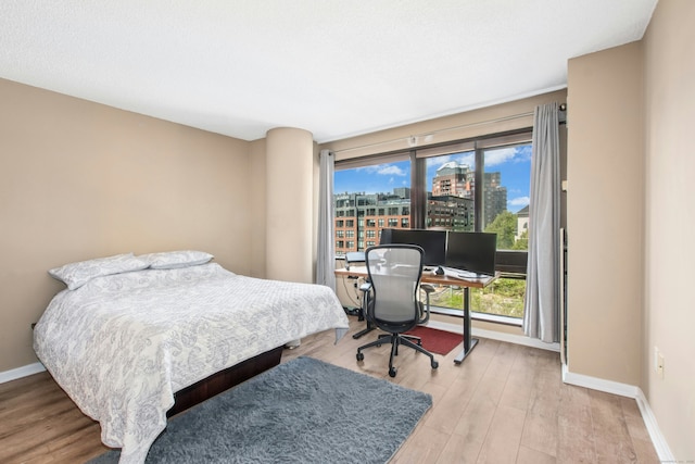 127 Greyrock Pl Unit 502, Stamford, CT 06901 - bedroom with baseboards, multiple windows, and light wood-type flooring