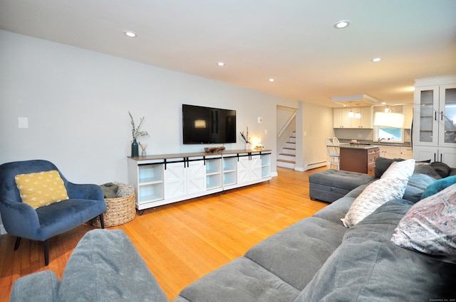 30 Taylor St, Windsor, CT 06095 - living room featuring light wood-type flooring, a baseboard radiator, stairway, and recessed lighting