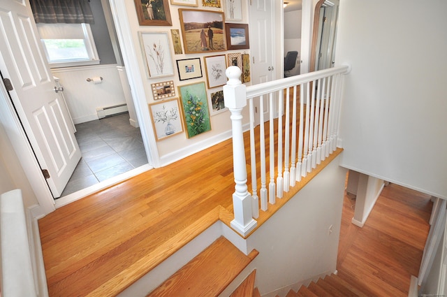 30 Taylor St, Windsor, CT 06095 - stairway with baseboard heating, wood finished floors, and baseboards