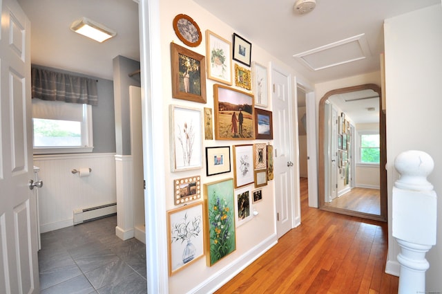 30 Taylor St, Windsor, CT 06095 - corridor with a baseboard heating unit, attic access, wainscoting, wood finished floors, and baseboards