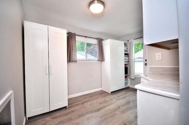 30 Taylor St, Windsor, CT 06095 - kitchen with light wood-style flooring, plenty of natural light, and white cabinets