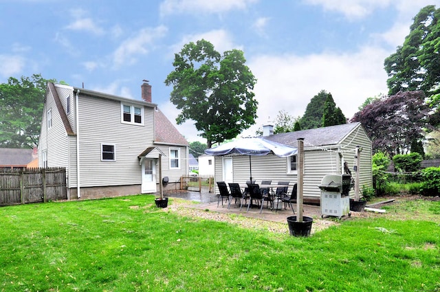 30 Taylor St, Windsor, CT 06095 - rear view of house featuring a chimney and a patio area