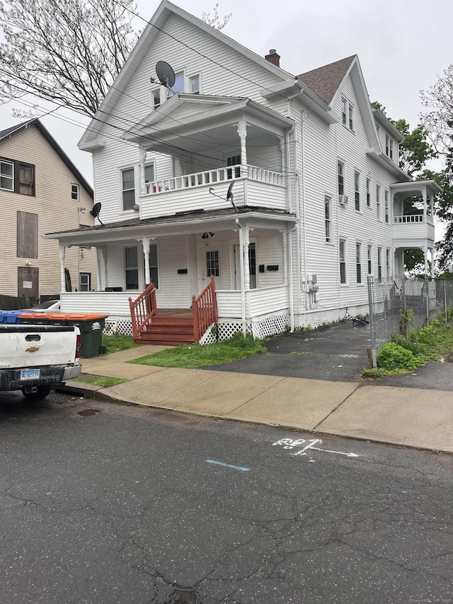 156 Hobart St, Meriden, CT 06450 - view of front of property featuring a balcony, covered porch, and a chimney