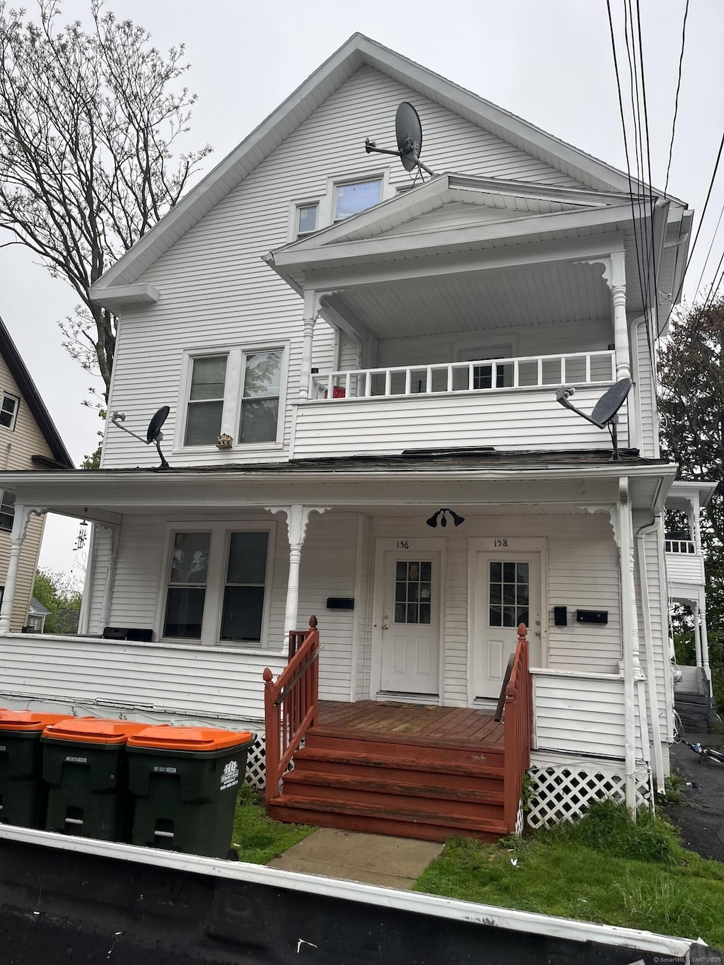 156 Hobart St, Meriden, CT 06450 - view of front facade with a balcony and a porch