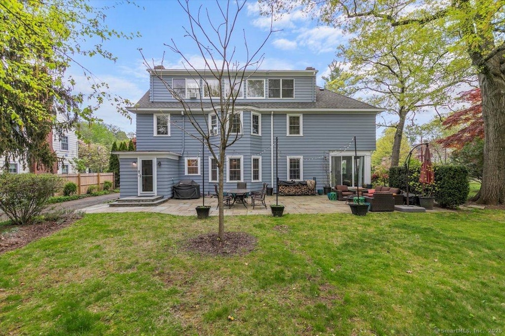 back of house featuring outdoor lounge area, a patio, entry steps, and roof with shingles