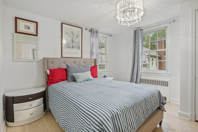 20 Fieldstone Dr, Easton, CT 06612 - bedroom featuring radiator, light wood-style floors, and a chandelier
