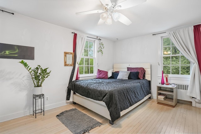 20 Fieldstone Dr, Easton, CT 06612 - bedroom featuring wood-type flooring, multiple windows, radiator heating unit, and a ceiling fan