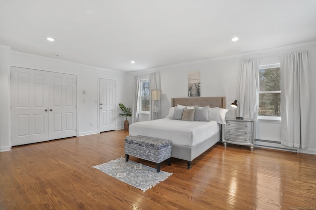 20 Fieldstone Dr, Easton, CT 06612 - bedroom featuring a baseboard heating unit, crown molding, wood finished floors, recessed lighting, and two closets