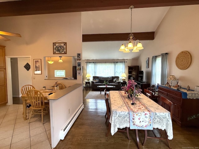 dining area with baseboard heating, a chandelier, light tile patterned floors, and ceiling fan